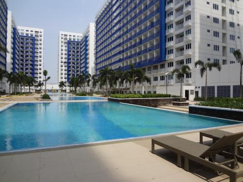 a large swimming pool in a city with tall buildings at manila sea view homes 21 in Manila