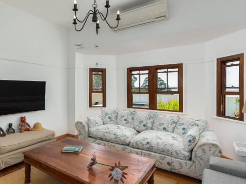 a living room with a couch and a coffee table at Abbotts Hill in Malmesbury