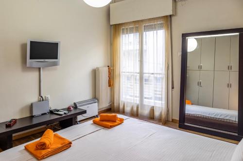 a bedroom with a large bed and a mirror at Dancing on Sunshine - Melina's City Getaway in Kalamata