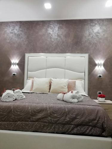 a bedroom with a large bed with towels on it at Royal Dreams in Caserta