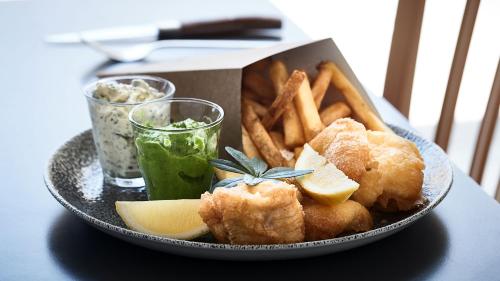 a plate of food with french fries and a box of food at HORISONT Hotel & Konference in Aarhus