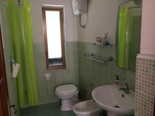 a bathroom with a toilet and a sink at La Casuccia in Ercolano