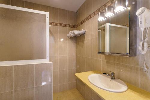 a bathroom with a sink and a mirror at Apartamentos Posidonia in Son Parc