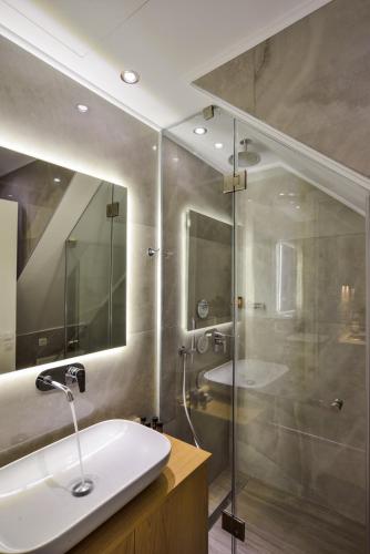 a bathroom with a sink and a glass shower at Elia Portou Luxury Residence in Chania