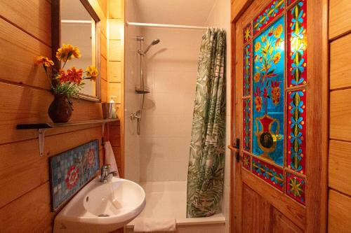 a bathroom with a sink and a stained glass window at Ezera Maja in Liepāja