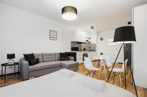a living room with a couch and a table at GoldAparts Centrum in Łódź