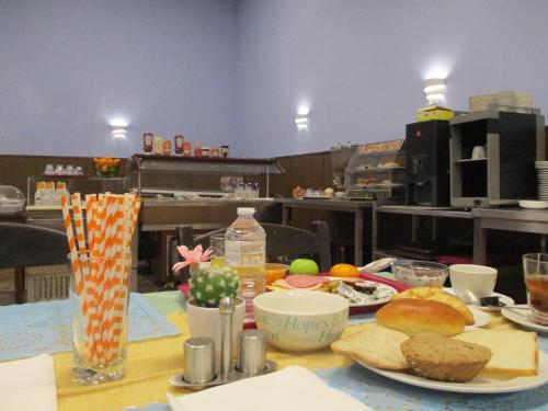 a table with a plate of food on it at Hotel de la Gare Aalst in Aalst