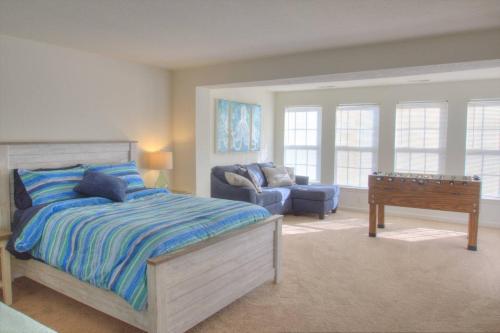 a bedroom with a bed and a couch and a desk at 34 Pier Point Dr in Millville