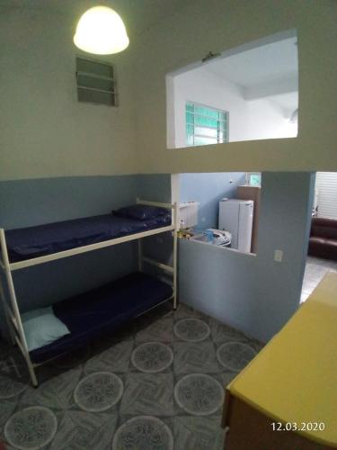 a room with three bunk beds in a room at Grace House in Caieiras