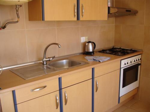 a kitchen with a sink and a stove at Acuarium 1 - Zand Properties in Benidorm
