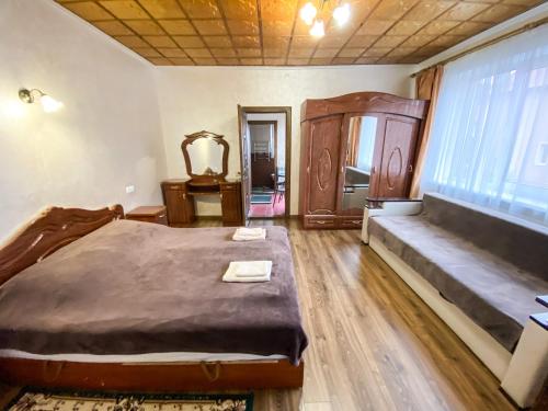a bedroom with a large bed and a large window at Maria in Solochyn