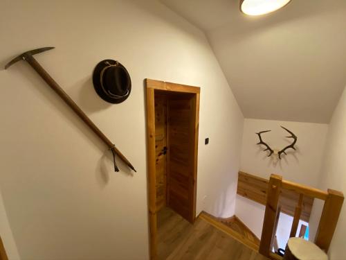 a hallway with a door and antlers on the wall at Chalet Apartments Maštal in Železná Ruda