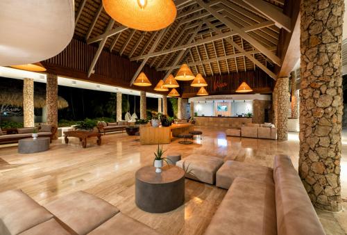 a lobby of a resort with couches and tables at Viva Dominicus Beach by Wyndham, A Trademark All Inclusive in Bayahibe