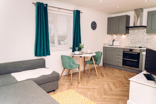 a living room with a couch and a table in a kitchen at Caroline Court - 1 Bedroom Apartment in Colchester