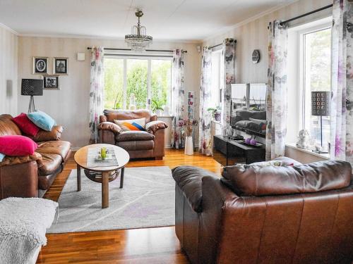 a living room with leather couches and a table at 10 person holiday home in KLÖVEDAL in Klövedal