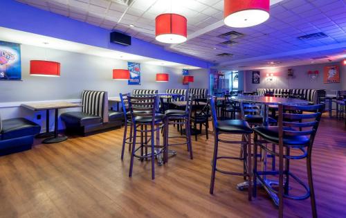 a room with tables and stools in a restaurant at Red Roof Inn PLUS Newark Liberty Airport - Carteret in Carteret