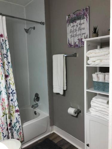 a bathroom with a shower and a toilet and towels at The Comfi Coral - Large 1 Bedroom Studio A in Baytown