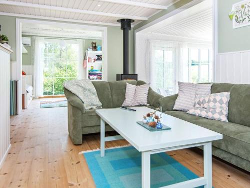 a living room with a couch and a table at 8 person holiday home in Ebeltoft in Ebeltoft