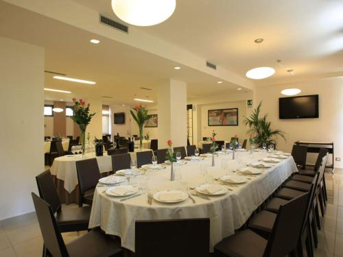 a large banquet room with a long table and chairs at La Costiera Hotel in Marina di Varcaturo