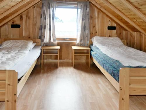 two beds in a room with a window at 4 person holiday home in Måndalen-By Traum in Sæbø