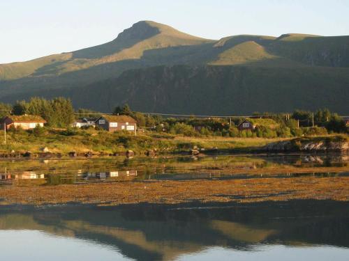 a body of water with houses and mountains in the background at 9 person holiday home in Farstad-By Traum in Farstad