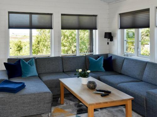 a living room with a couch and a coffee table at 9 person holiday home in Farstad-By Traum in Farstad