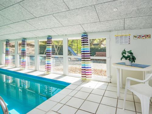 a swimming pool in a room with a swimming pool at 12 person holiday home in Glesborg in Fjellerup Strand