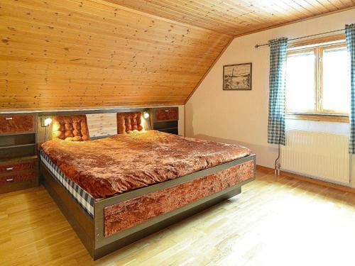 a bedroom with a large bed with a wooden ceiling at 17 person holiday home in MELLERUD-By Traum in Dals Rostock