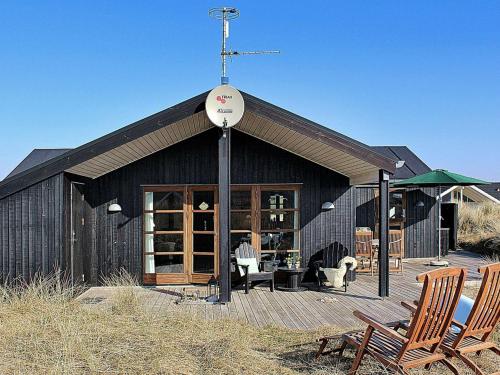 a building with a weather vane on top of it at 6 person holiday home in Hvide Sande in Hvide Sande