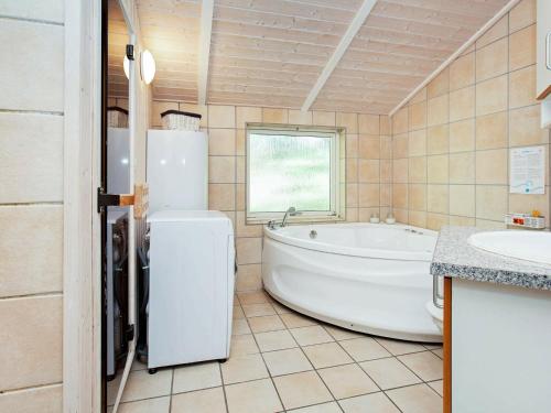 a large bathroom with a tub and a sink at Five-Bedroom Holiday home in Juelsminde 1 in Slagelse
