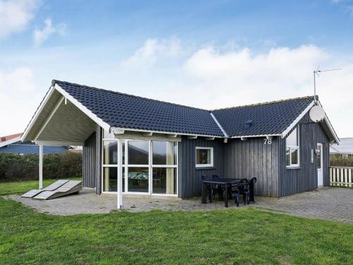 a house with a solar roof and a table at 6 person holiday home in Harbo re in Harboør