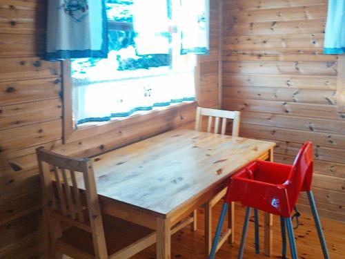 a wooden table and two chairs in a room at 8 person holiday home in Norheimsund-By Traum in Norheimsund
