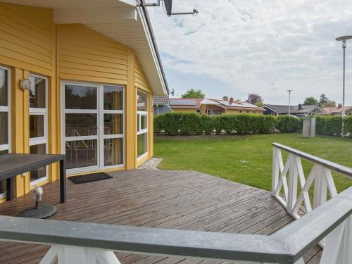 a large wooden deck on the side of a house at 6 person holiday home in GROEMITZ in Grömitz