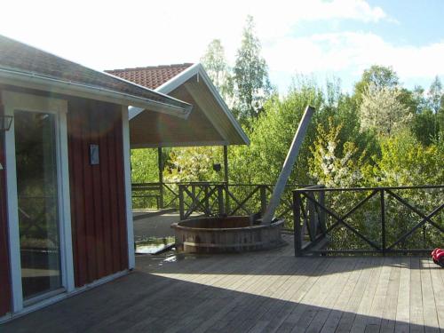 a porch of a house with a patio at 8 person holiday home in GR NNA in Målskog