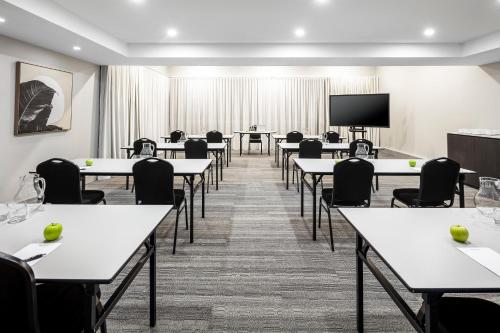 a conference room with tables and chairs and a tv at Quest Wangaratta in Wangaratta
