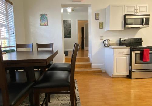 a kitchen and dining room with a table and a dining room at Miami Beach Rooms B&B in Miami Beach