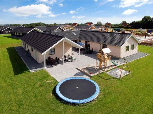 an aerial view of a house with a trampoline in the yard at 22 person holiday home in Sydals in Sønderby