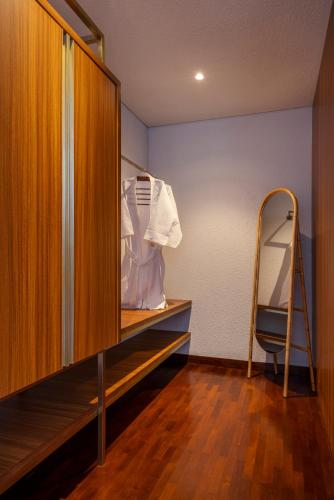 a closet with a wooden cabinet and a ladder at Zenubud in Ubud