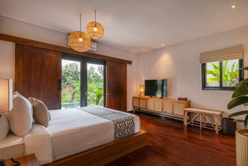 a bedroom with a bed and a large window at Zenubud in Ubud
