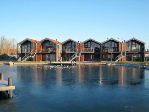 ボーゲンセにある4 person holiday home in Bogenseの湖前の建物
