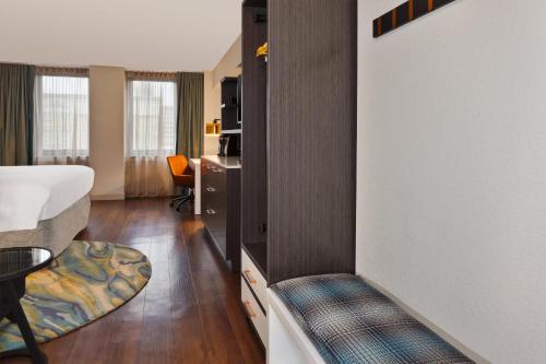 a hotel room with a bed and a couch in a room at Hotel Indigo Rochester - Mayo Clinic Area in Rochester