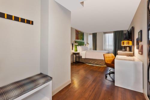 a room with a bed and a desk with a chair at Hotel Indigo Rochester - Mayo Clinic Area in Rochester