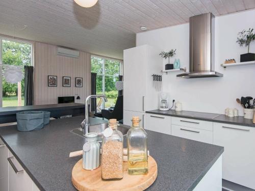 eine Küche mit Spüle und zwei Flaschen auf der Theke in der Unterkunft 8 person holiday home in Glesborg in Fjellerup Strand