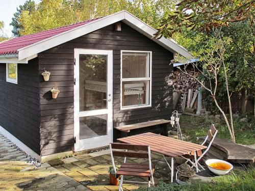 a small cabin with a window and a picnic table at 5 person holiday home in Stege in Stege