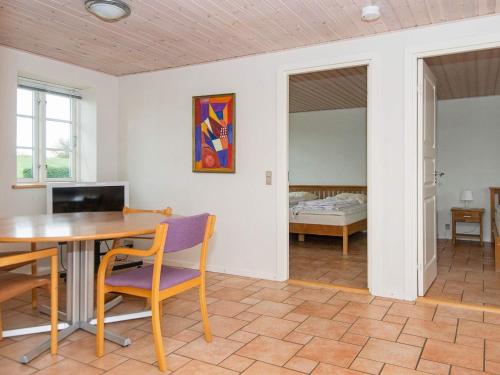 a room with a table and chairs and a bedroom at 20 person holiday home in Nordborg-By Traum in Nordborg