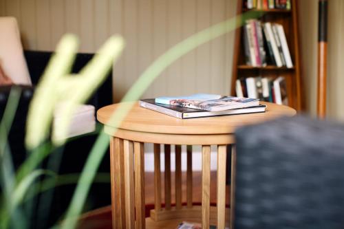 a small wooden table with a book on it at Hotell Uddewalla in Uddevalla