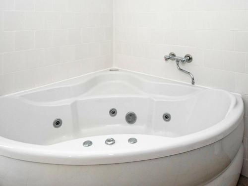 a white bath tub in a white bathroom at 8 person holiday home in Gjern in Gjern