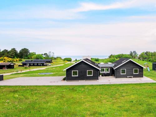 a group of houses on a grassy field at 20 person holiday home in Glesborg in Glesborg