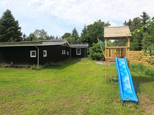 a playground with a blue slide and a gazebo at 8 person holiday home in Hals in Hals