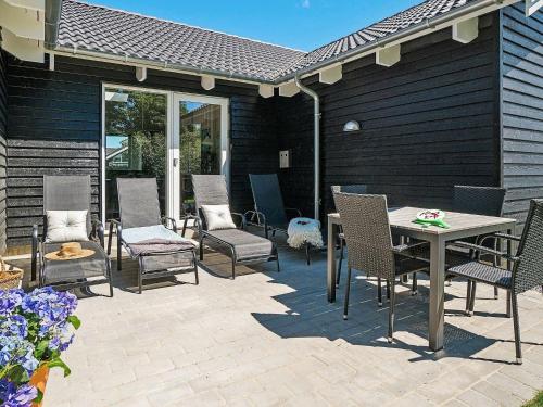 a patio with chairs and a table on a patio at 18 person holiday home in Hasselberg in Kappeln